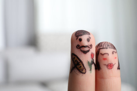 Two fingers with drawings of happy faces on blurred background, space for text. Spending time togetherの写真素材