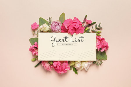 Beautiful flowers and guest list on beige background, flat layの写真素材