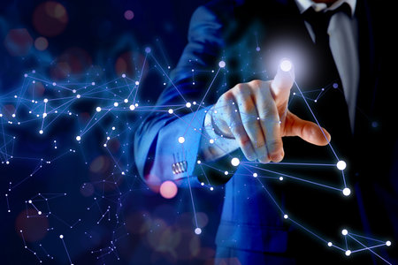 Man using virtual screen with connection lines presenting innovation network linkage on dark backgroundの写真素材