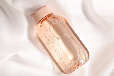 Bottle of micellar water on white fabric