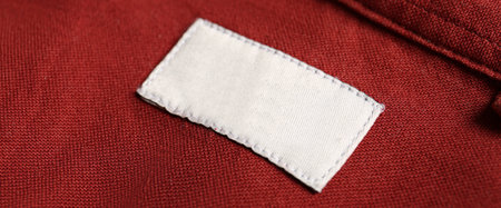 Blank clothing label on red shirt, closeup. banner design