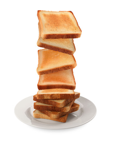 Delicious toasted bread falling into plate on white backgroundの写真素材