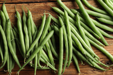 Fresh green beans on wooden table, flat layの写真素材
