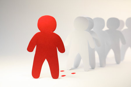 White paper human figures following red one on light background. Responsibility conceptの写真素材