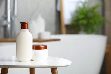 Shampoo and hair mask on white table in bathroom, space for textの写真素材