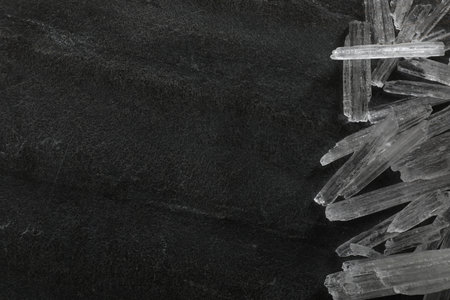 Menthol crystals on gray background, flat lay. Space for text