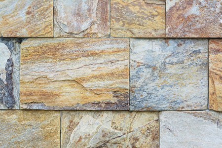 Wall with marble stone tiles as background, closeup
