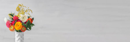 Vase with beautiful ranunculus flowers on light background, space for text. banner designの写真素材