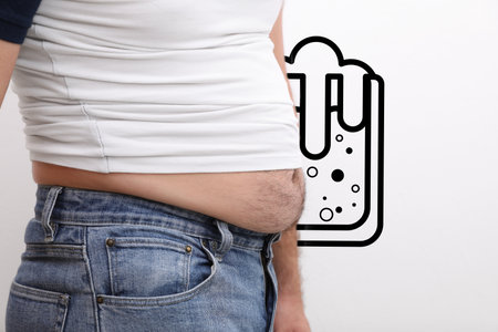 Beer belly problem. Overweight man on white background, close upの写真素材