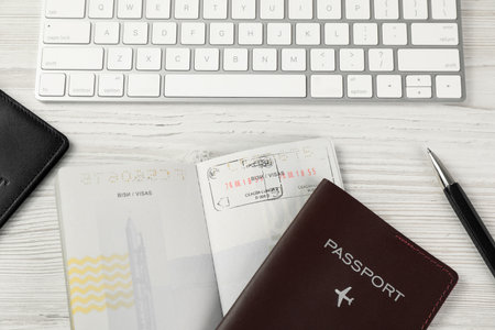 Moldova, Ceadir-Lunga - June 13, 2022: Passports with visa stamps, computer keyboard and pen on...
