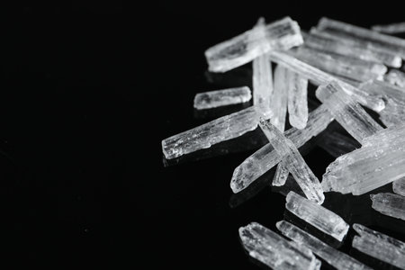 Menthol crystals on black background, closeup. Space for textの写真素材