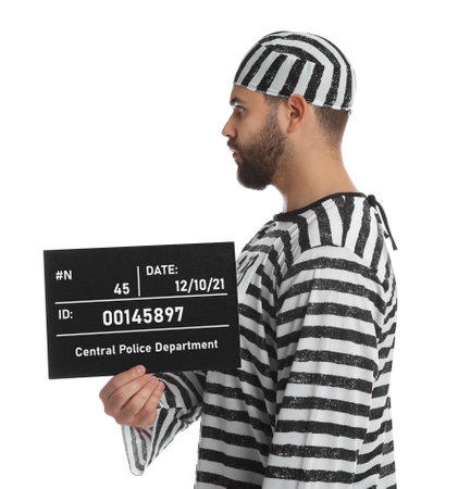 Prisoner in special uniform with mugshot letter board on white backgroundの写真素材