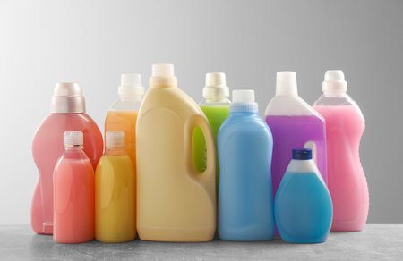 Different bottles with detergents on gray tableの写真素材
