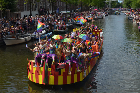 AMSTERDAM, NETHERLANDS - AUGUST 06, 2022: Many people in boats at LGBT pride parade on riverのeditorial素材