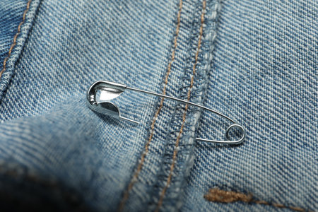 Close up view of metal safety pin on clothing