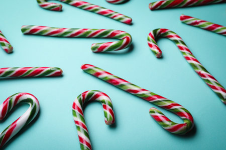 Many sweet Christmas candy canes on turquoise backgroundの写真素材