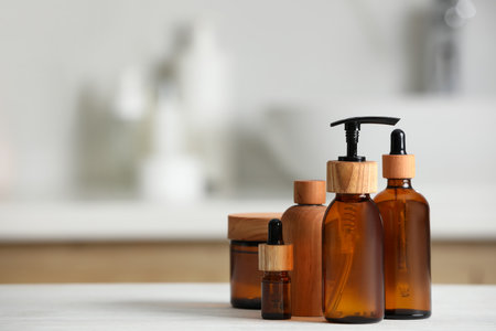 Different personal care products on white wooden table in bathroom. Space for textの写真素材