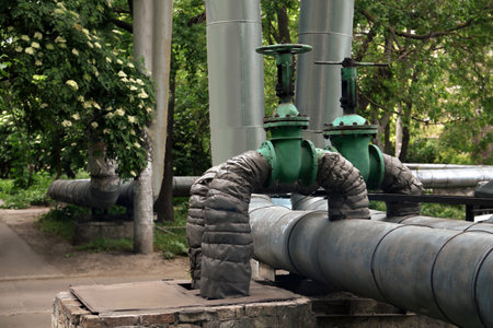 Old pipes with valve gate on city street