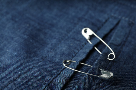 Closeup view of metal safety pins on clothingの写真素材