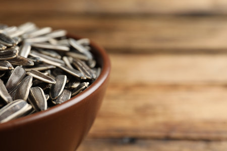 Raw sunflower seeds in bowl, closeup. Space for textの写真素材