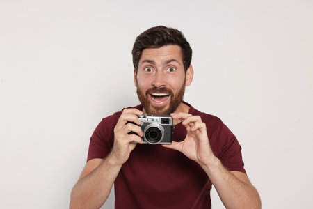 Man with camera on white background. interesting hobbyの写真素材