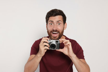 Man with camera on white background. interesting hobbyの素材 [FY310191637395]