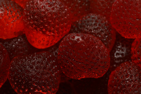 Delicious gummy strawberry candies as background, closeup