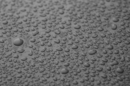 Many water drops on gray background, closeupの写真素材