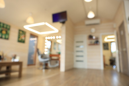 Blurred view of stylish barbershop interior with professional hairdresser's workplaceの写真素材