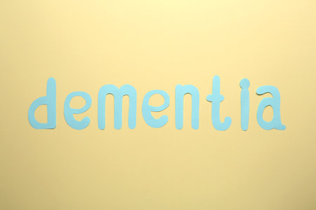 Word Dementia made of paper letters on beige background, flat layの写真素材