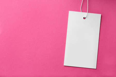 Tag with space for text on pink background, top viewの写真素材