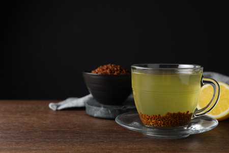Buckwheat tea and granules on wooden table, space for textの写真素材