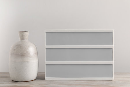Blank letter board and vase on wooden table. Mockup for design