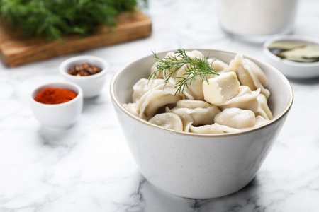 Tasty dumplings in bowl served on white marble tableの素材 [FY310191832170]