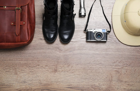 Flat lay composition with different safari accessories on wooden background, space for textの写真素材