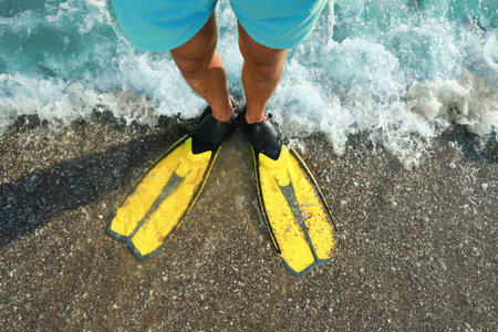 top view of man in flippers on beachの写真素材