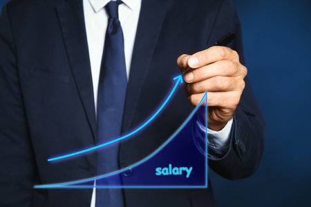 Salary increase concept. Man drawing up arrow on virtual screen, closeupの写真素材