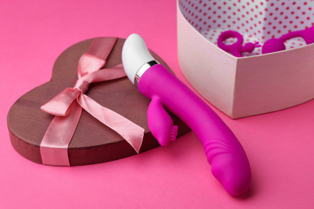 Gift box with sex toys on pink backgroundの写真素材