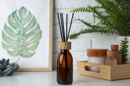 Air reed freshener, decor and cosmetic products on white table indoorsの写真素材