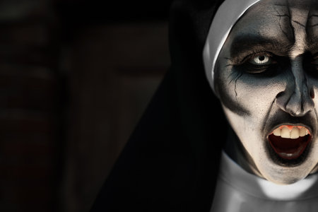 Portrait of scary devilish nun on blurred background, closeup with space for text. halloween party lookの写真素材