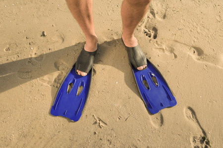 Man in flippers on wet sand, closeupの写真素材