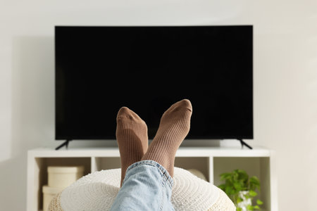 Woman having rest at stylish TV set, closeupの写真素材