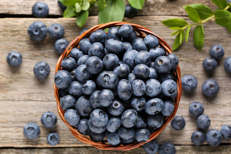 Tasty fresh blueberries on wooden table, flat layの写真素材