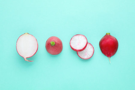 Fresh ripe radish on turquoise background, flat lay