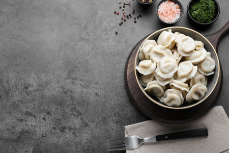 Tasty dumplings in bowl served on table, flat lay. Space for textの写真素材
