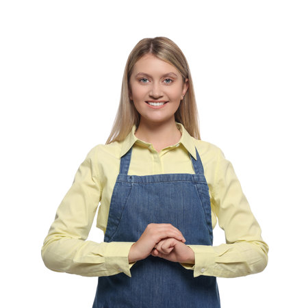 Beautiful young woman in denim apron on white backgroundの写真素材