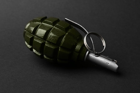 Hand grenade on black background, closeup. Explosive weaponの写真素材