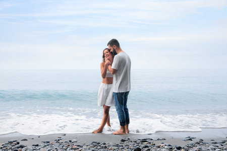 Happy young couple on the beach near the seaの写真素材