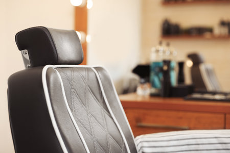 Closeup view of professional barber chair in hairdressing salonの写真素材