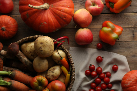 Different fresh ripe vegetables and fruits on wooden table, flat layの写真素材
